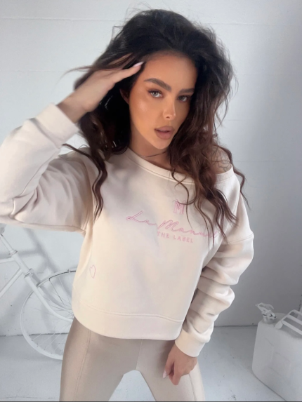 Śmietankowa bluza z wyszywanym różowym logiem La Manuel.